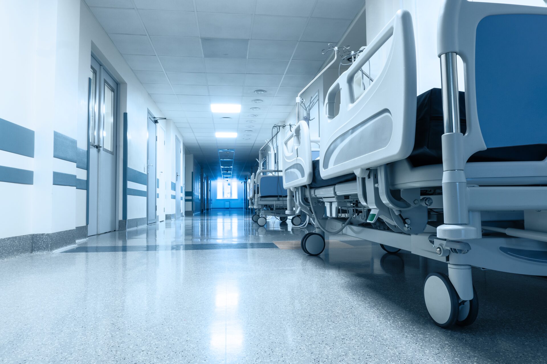 A hospital corridor lined with empty beds