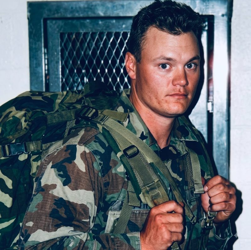 Jason W. Voelke in field utilities with a medical pack
